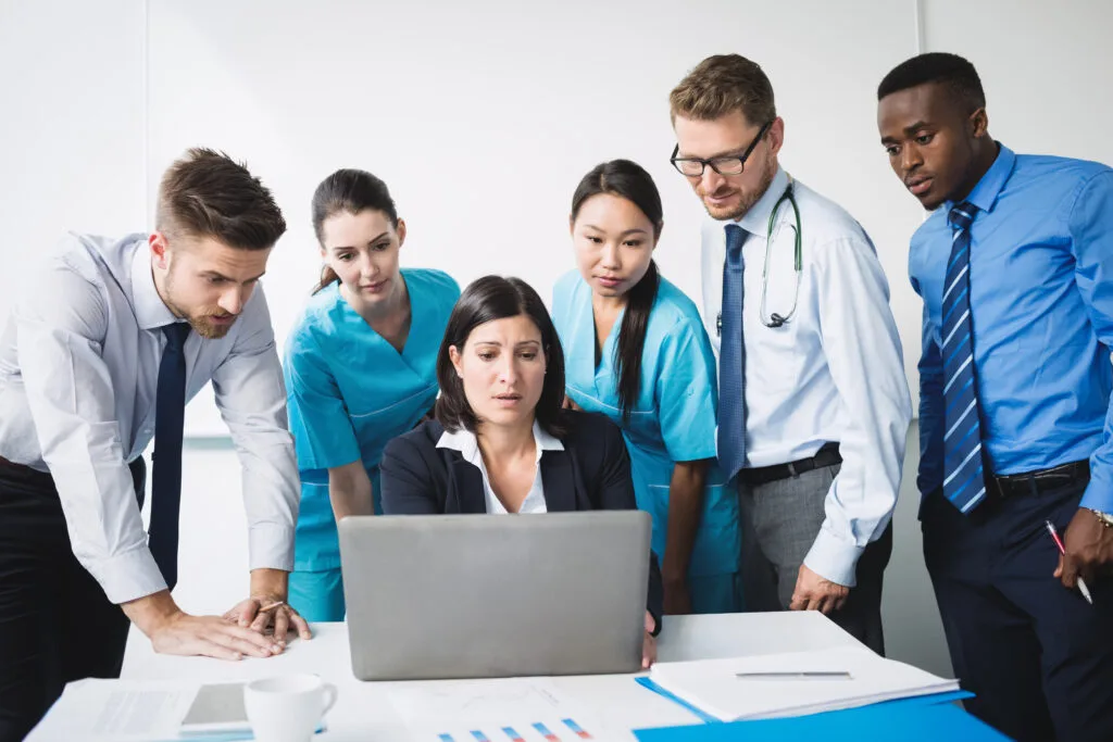 About Us 8 team doctor discussing laptop meeting